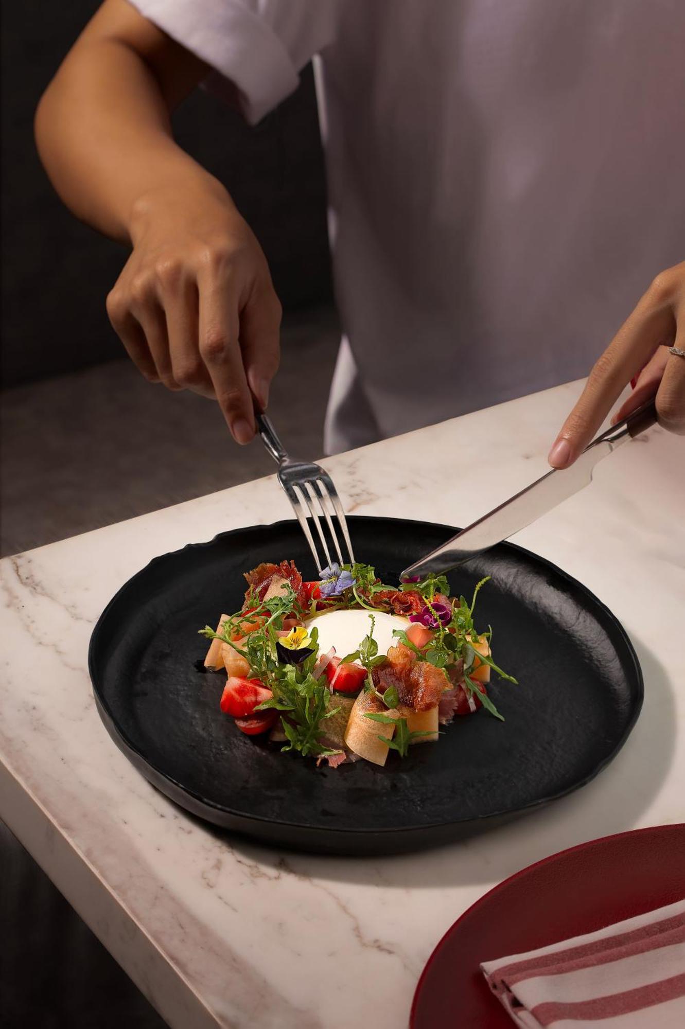 Melia Vinpearl Hue Hotel Exterior photo A salad being cut with a knife and fork