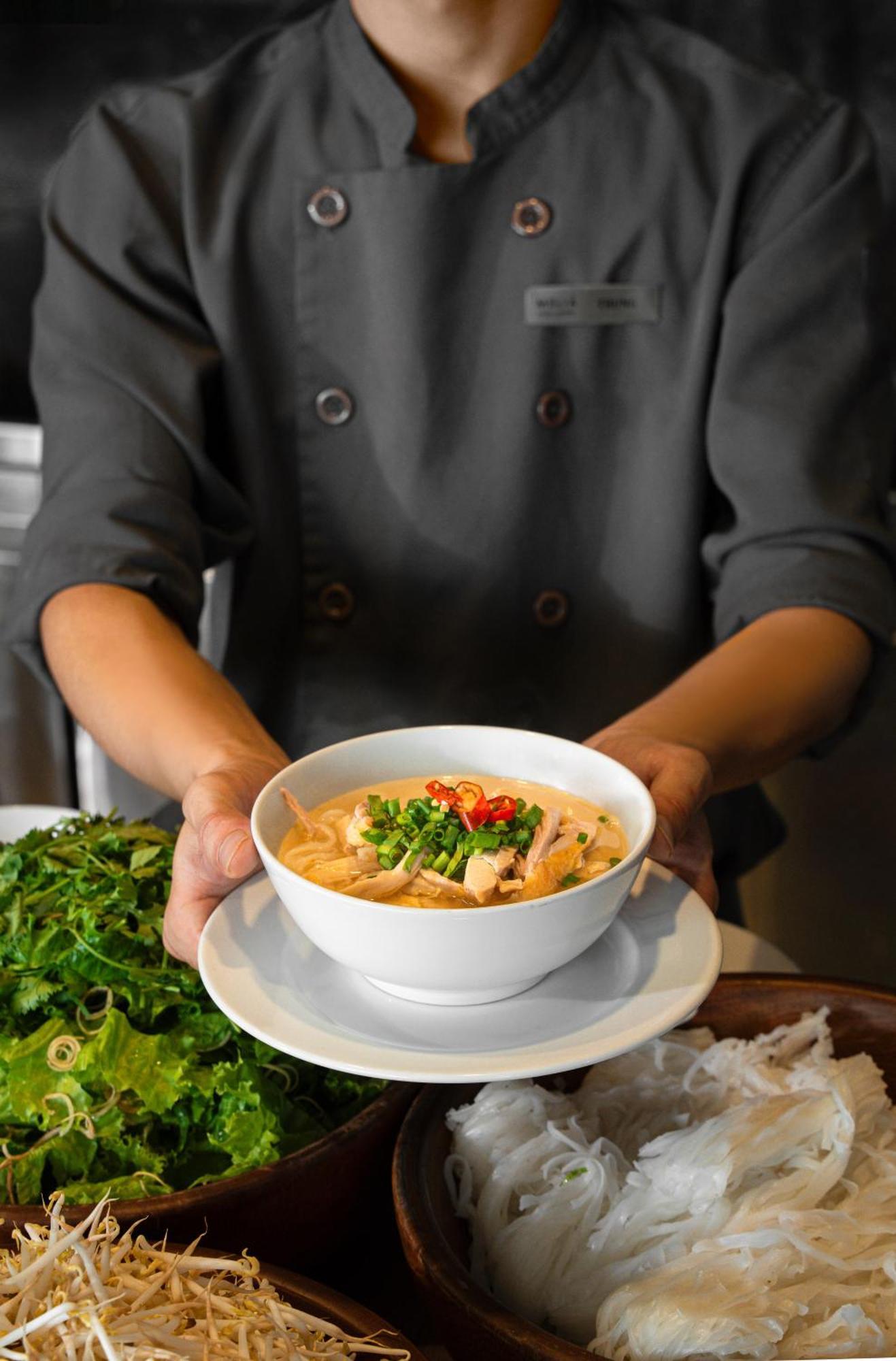 Melia Vinpearl Hue Hotel Exterior photo A chef holding a bowl of Tom Kha soup